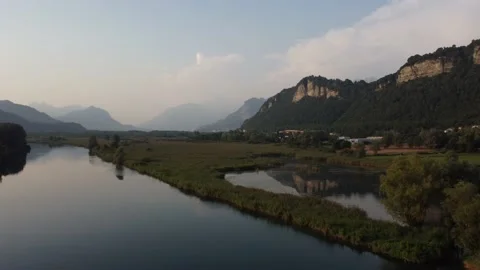Aerial view of a river at sunset with ducks and mountains Stock Footage 160685744