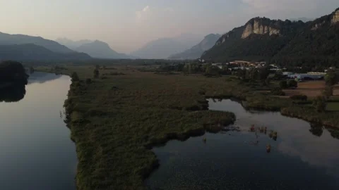 Aerial view of a river at sunset with ducks and mountains Stock Footage 160689050