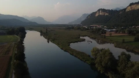 Aerial view of a river at sunset with ducks and mountains Stock Footage 160720258
