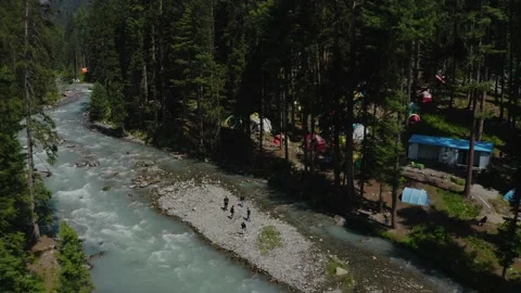 Aerial view of a river surrounded by green trees in the mountains Stock Footage 171908321