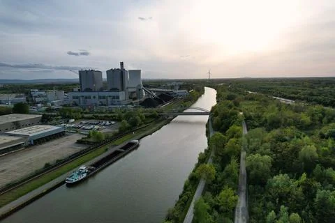 An aerial view of a river surrounded by trees and industry buildings and a Stock Photos