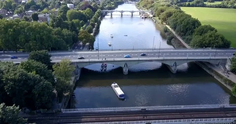 Aerial view river Thames with traffic crossing &amp; Richmond lock &amp; footbridge Stock Footage 80296024
