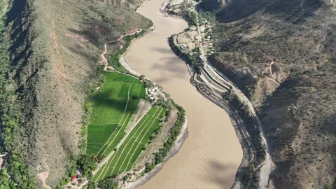 Aerial view of river valley with rice fields and mountain road Stockbeeldmateriaal 332946080