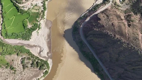 Aerial view of river valley with rice fields and mountain road Stockbeeldmateriaal 332946085