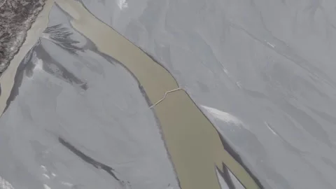 Aerial view of a river winding through a mountainous landscape in Pakistan 스톡 동영상 314455099