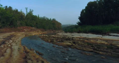Aerial view of river winding through misty tropical forest at sunrise 스톡 동영상 332885194