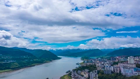Aerial View of a River Winding Through Mountains and a Riverside City 스톡 동영상 342093346