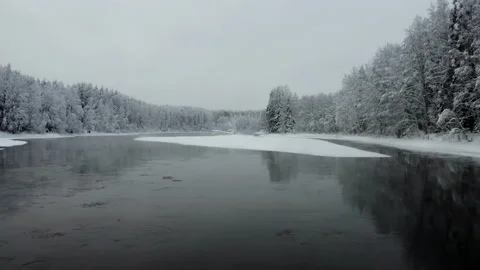 Aerial view of the river into the winter forest Stock Footage 173615411
