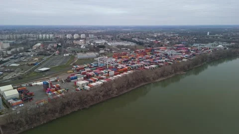 Aerial view of a riverfront container terminal in Csepel under overcast sky Stock Footage 336468291