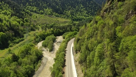 Aerial view of a road along a mountain river in spring Stock Footage 338005751