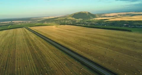 Aerial view of the road among the fields outside the city Stock Footage 158398949