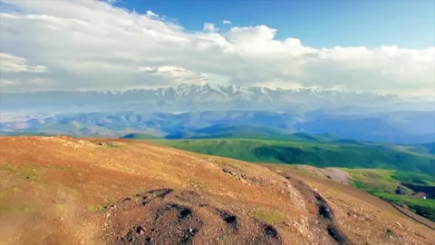 Aerial view of an off road ATV quad bike riding on a dusty mountain ridge Stock Footage 337023707