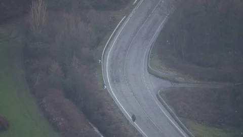 Aerial view of a road between fields and trees Stock Footage 84881761