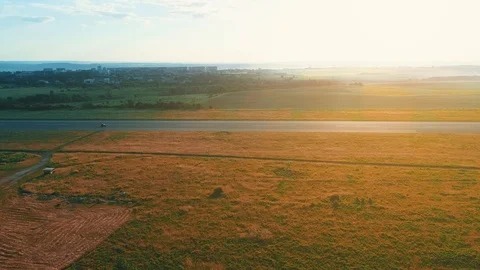 Aerial view of the road between fields. Summer colors. Aerial of green Stock Footage 113080570