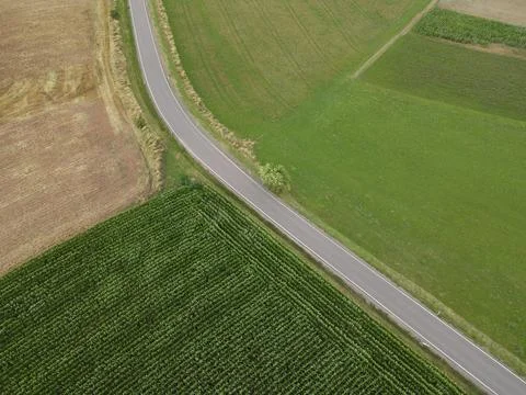 Aerial view of a road between fields in the landscape Stock Photos