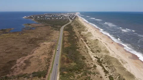 Aerial view of road between oceanside and soundside. 4k Stock Footage 104588687