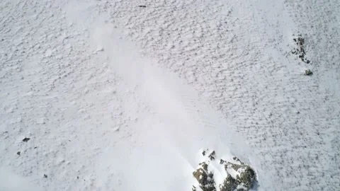 Aerial view on a road between the white snowy hills with cars driving on it Video stock 154129711