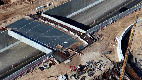 Aerial View of Road Bridge Construction Site with Crane and Machinery Stock Footage 342052497