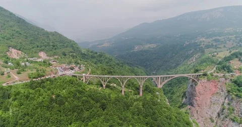 Aerial view of a road bridge in mountains Stock Footage