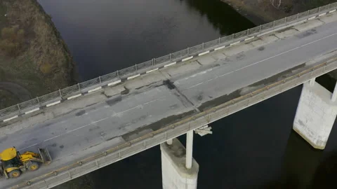 An aerial view of a road bridge over a river in the forest. Stock Footage 134099061