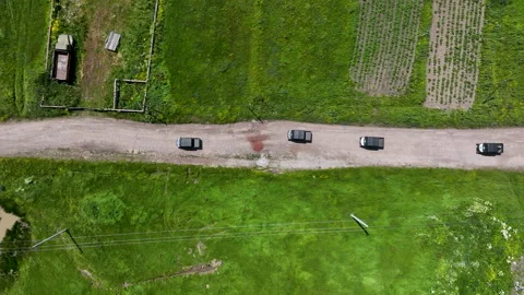 Aerial view of off-road buggies driving through scenic green mountains Stock Footage 341101780