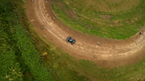 Aerial view of off road buggy racing on a winding dirt track Stock Footage 336402783