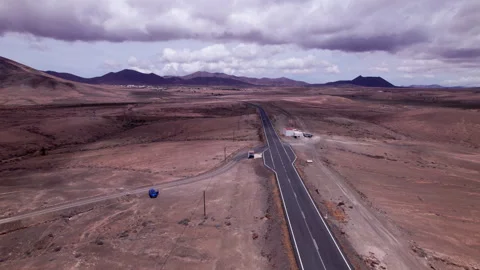 Aerial view of road cutting through rugged terrain Stock Footage 310396697