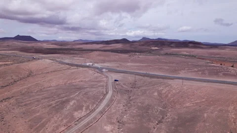 Aerial view of road cutting through rugged terrain, Fuerteventura Stock Footage 310397793
