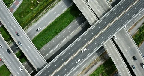 Aerial view of road interchange of highway intersection with cars speeding Stock Footage 112116019