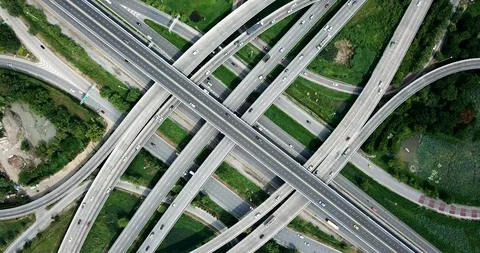 Aerial view of road interchange of highway intersection with cars speeding Stock Footage 112117350