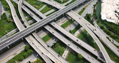 Aerial view of road interchange of highway intersection with cars speeding Stock Footage 112119094
