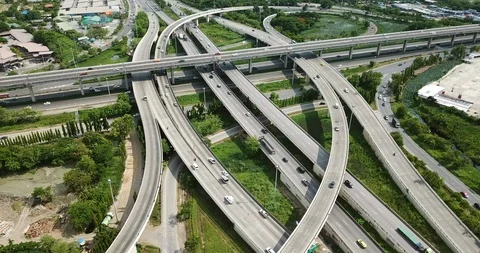 Aerial view of road interchange of highway intersection with cars speeding Stock Footage 112120301