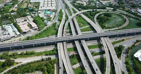 Aerial view of road interchange of highway intersection with cars speeding Stock Footage 112120318