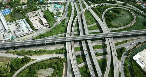 Aerial view of road interchange of highway intersection with cars speeding Stock Footage 112120429