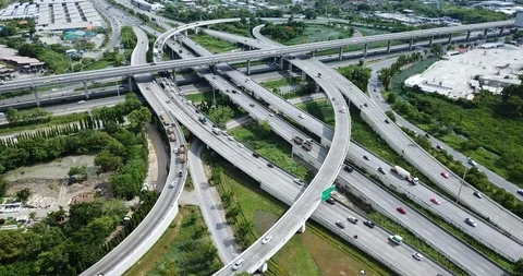 Aerial view of road interchange of highway intersection with traffic speeding Stock Footage 112233230