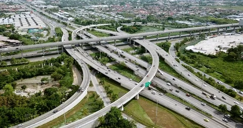 Aerial view of road interchange of highway intersection with traffic speeding Stock Footage 112234064