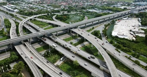 Aerial view of road interchange of highway intersection with traffic speeding Stock Footage 112234987