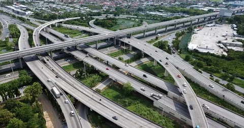 Aerial view of road interchange of highway intersection with traffic speeding Stock Footage 112234997