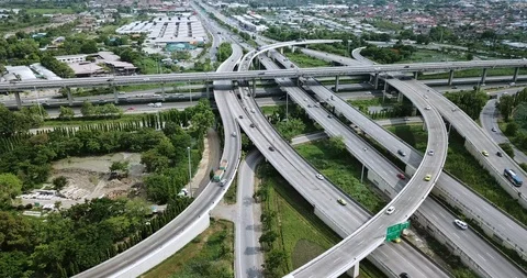 Aerial view of road interchange of highway intersection with traffic speeding Video stock 112235586