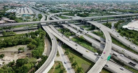 Aerial view of road interchange of highway intersection with traffic speeding Stock Footage 112236124