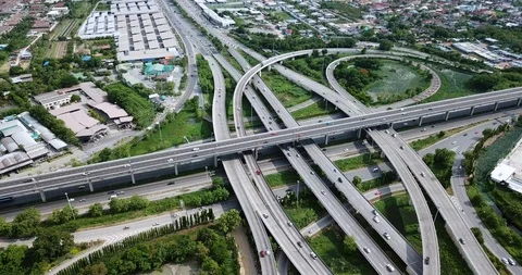 Aerial view of road interchange of highway intersection with traffic speeding Stock Footage 112236932