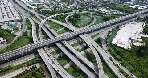 Aerial view of road interchange of highway intersection with traffic speeding Video stock 112237264