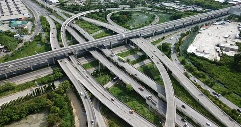 Aerial view of road interchange of highway intersection with traffic speeding Video stock 112237357