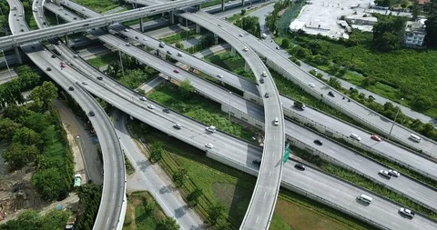 Aerial view of road interchange of highway intersection with traffic speeding Video stock 112237474