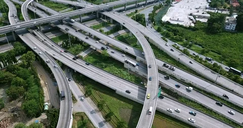 Aerial view of road interchange of highway intersection with traffic speeding Video stock 112237545