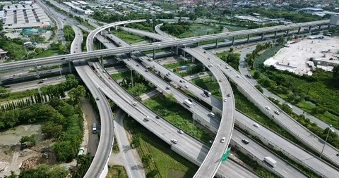 Aerial view of road interchange of highway intersection with traffic speeding Video stock 112237610