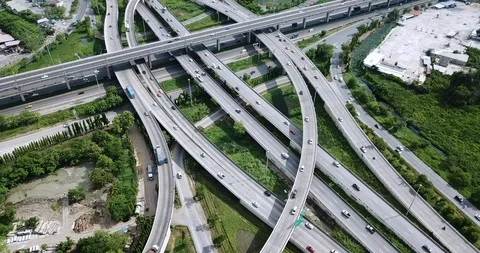 Aerial view of road interchange of highway intersection with traffic speeding Video stock 112237751
