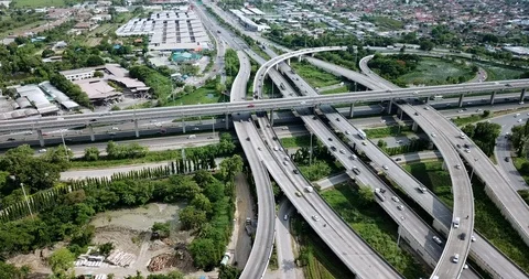 Aerial view of road interchange of highway intersection with traffic speeding Video stock 112237871