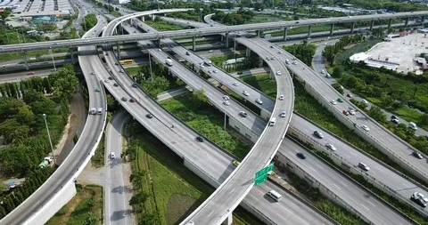 Aerial view of road interchange of highway intersection with traffic speeding Video stock 112237905