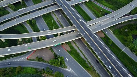 Aerial view of road interchange of highway intersection with traffic speeding Video stock 114792136